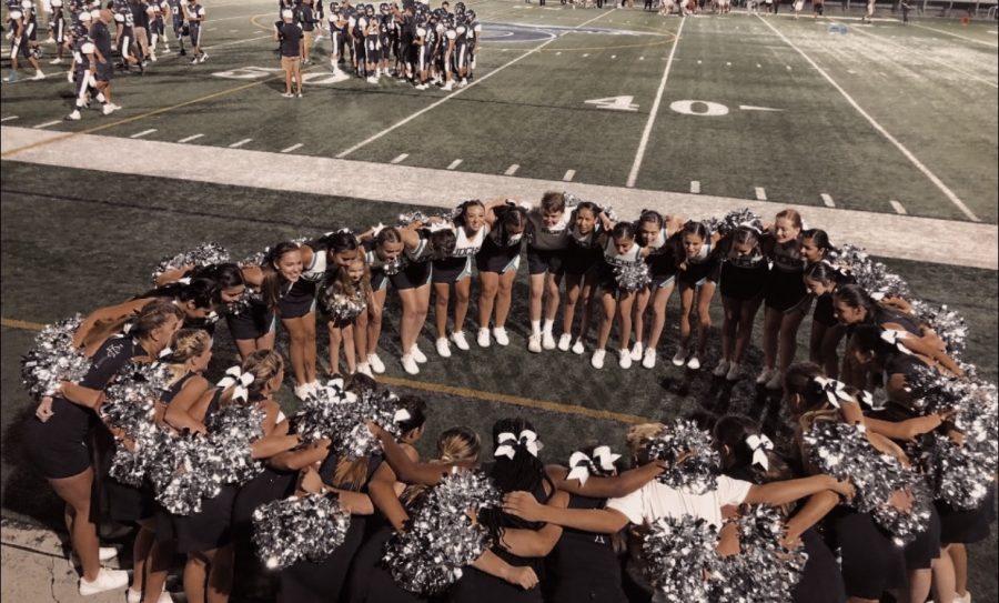 The 2019-2020 Juan Diego  Cheer team huddled up before their first halftime. 
