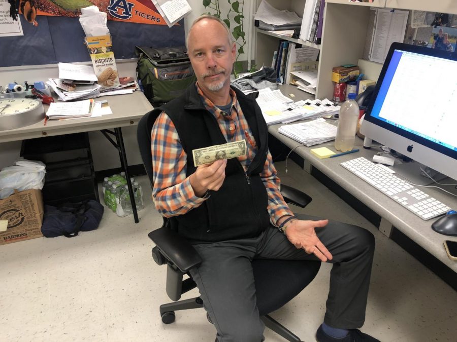 Gregg Alex holds a dollar with disappointment because hes unfortunately not a billionaire.  
Photo taken by me. 