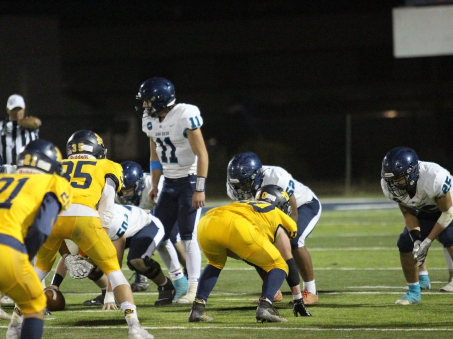 JDCHS football lines up against Summit Academy as Junior Tyler Easter prepares to receive the ball.